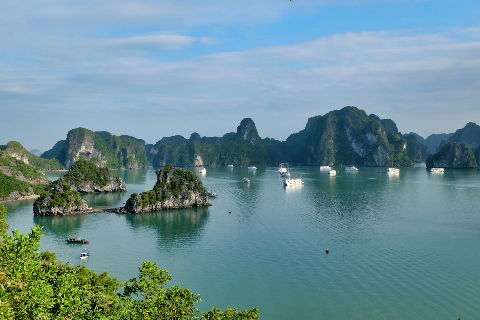 Limestone karst islands rising from emerald water in Ha Long Bay, Vietnam