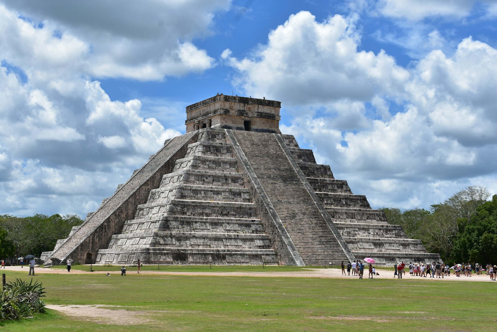 The Pyramid of Kukulcán at Chichén Itzá, Mexico, under a blue sky