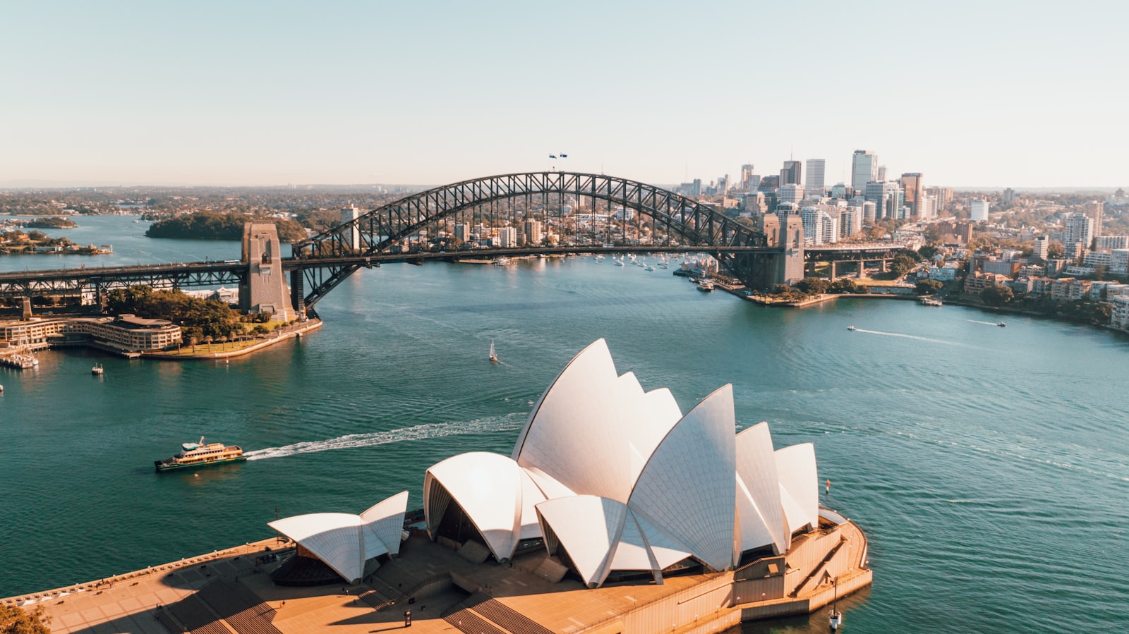 Aerial view of Sydney Opera House and the Harbour Bridge at golden hour